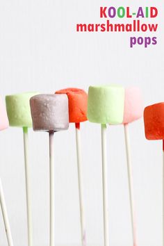 four marshmallow pops are lined up in a row with the words koola - aid marshmallow pops above them