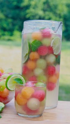 a jar filled with fruit sitting on top of a wooden table