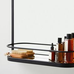 a shelf that has some bottles and a brush on it