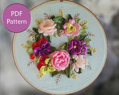 an embroidery project with flowers on it and the words pdf pattern above it in pink