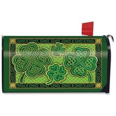 a green and black mailbox with shamrocks on the front, and two clovers in