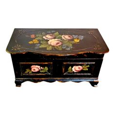 an old wooden box with flowers painted on it's sides and drawers in the bottom