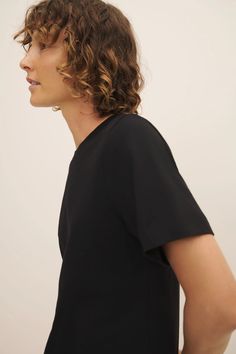 FINAL SALE Please note that this is a Final Sale item. No returns or exchanges will be accepted. Classic Tee in Black by Kowtow. A short sleeve tee with a standard fit through the body and a ribbed crew neck. The perfect everyday tee, made from 100% certified Fairtrade mid-weight organic cotton jersey. Sizing + Details → Made In New Zealand 100% Organic Jersey Cotton Machine Wash, Lay Flat Or Tumble Dry Shimma Stands 5'9" And Wears M XS — Chest (PTP) 19", Hip 19", Length 25" S — Chest (PTP) 20", Black Crew Neck Top With Minimal Stretch, Classic Fitted Short Sleeve Top, Fitted Black T-shirt For Work, Black Short Sleeve Top For Everyday Spring Wear, Everyday Black Short Sleeve Top For Spring, Sleek Crew Neck Summer Tops, Sleek Crew Neck Tops For Summer, Sleek Crew Neck Tops For Work, Sleek Crew Neck Tops For Workwear