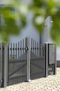 an iron fence is shown in front of a house