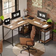 an office desk with two computer monitors on it and a chair in front of the desk