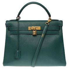 Rare and in one of the most precious leathers of the house Hermès: Hermes Kelly 32 handbag returned strap in Vert Malachite Vache Ardennes leather, gold plated metal hardware, green leather handle, removable shoulder strap in green leather allowing a hand or shoulder carry Flap closure Green leather lining, one zippered pocket, two patch pockets Signature: "Hermès Paris Made in France" Date: Y circle (1995) Dimensions: 32 x 23 x 12 cm (12.6 x 9 x 4.72 Inches) Reference: 100489 General condition: Hermes Kelly 32, Kelly 32, Spring Essentials, Kelly Bag, Vintage Hermes, Hermes Paris, Hermes Handbags, Hermes Bags, Metal Hardware