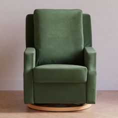 a green chair sitting on top of a hard wood floor