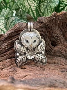 "Peaceful owl sits peacefully amongst a flower and ferns watching the world and camouflaged by the greenery. The original was recently sold but I will make a limited number of these on a made to order basis. L: including bail 1.75\" W: 1.3\" 16.1 g total weight All the silver is solid sterling.   The owl face is a hand painted, porcelain clay owl which was made by Lana Manna in the Czech Republic.  The owls I use are incredibly detailed and the porcelain is fired at a high temperature making it Owl Jewelry Necklace, Owl Face, Owl Designs, Clay Owl, Metalsmithing Jewelry, Precious Metal Clay, Owl Jewelry, Owl Pendant, Porcelain Clay