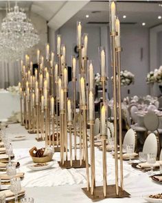 the table is set up with candles and place settings for an elegant dinnereon party