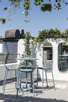 an outdoor table and chairs on a patio