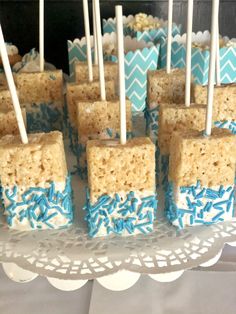 rice krispy treats with blue and white sprinkles on a cake plate