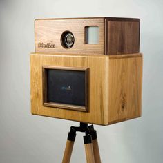 an old fashioned wooden camera on a tripod