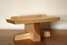 a small wooden bench sitting on top of a table