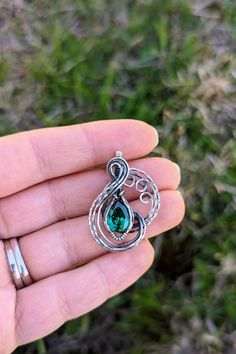 Another day, and another beautiful piece is in shop. This is a teal cubic zirconia wrapped in silver filled wire, and oxidized. I love how this piece turned out. Mythical, yet royal looking. It is a unique piece and I now have it available in my Etsy. Hand Forged Antique Silver Jewelry As Gift, Silver Emerald Teardrop Pendant Jewelry, Hand Forged Antique Silver Jewelry Gift, Hand Forged Antique Silver Jewelry For Gift, Collectible Oxidized Pendant Jewelry, Antique Jewelry With Lost Wax Casting Round Pendant, Unique Oval Pendant Jewelry With Oxidized Finish, Unique Jewelry With Oxidized Finish Oval Pendant, Unique Oxidized Oval Pendant Jewelry