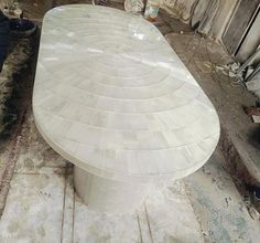 a large white table sitting on top of a wooden floor