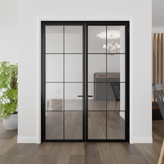 an empty room with wooden floors and sliding glass doors that lead into the dining area