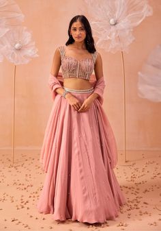 Make a stunning impression with this blouse featuring all-over 3D applique work, embellished with pearls and zari detailing. Paired with a matching skirt and dupatta, this ensemble blends intricate craftsmanship with sophisticated design, perfect for any special occasion. Crop Top Lehenga Wedding Indian Fashion, Lehenga Crop Top Designs, Crop Top Lehenga Wedding, Pink Georgette Lehenga, Blush Pink Lehenga, Plain Lehenga, Embellished Lehenga, Bridesmaid Dresses Indian, Peach Lehenga