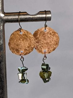 These are Hand hammered copper with green shell hangings. They are not clear coated and will patina with age, but are easy to polish. Handmade Copper Green Earrings, Handmade Green Copper Earrings, Green Copper Earrings With Patina, Green Hammered Bohemian Jewelry, Rustic Hammered Copper Earrings, Handmade Rustic Green Earrings, Rustic Handmade Green Earrings, Rustic Green Dangle Earrings, Green Rustic Dangle Earrings