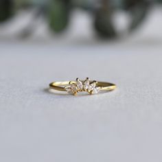 DESCRIPTION: >Add more sparkles to your solitaire ring with this enhancer. >Gold vermeil 925 Sterling Silver fully hallmarked. >Sterling silver is an almost pure metal made from 92.5% Silver. >Six, 3mm marquise cubic zirconia stones >Approx 1mm band width, 5mm length each leaves. FREE SHIPPING USA- All of our jewelry will arrive in custom packaging ready for gift giving. CARE: To prolong the color and shine of your jewelry, avoid contact with perfume, lotion, and water. Store in a Minimalist Cluster Ring With Prong Setting, Dainty Sterling Silver Half Eternity Ring, Ring Wraps, Enhancer Ring, Tiara Ring, Ring Enhancer, Perfume Lotion, Ring Guard, Marquise Ring