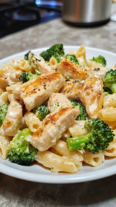 pasta with chicken and broccoli on a white plate