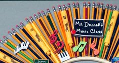 many different colored pencils and markers are arranged in the shape of a fan with a sign that says, ms daniels music class