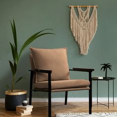 a living room with a chair, table and potted plant