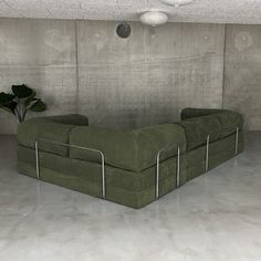 a green couch sitting in the middle of a room