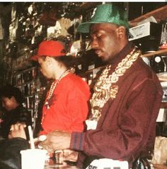 two men are sitting at a table in a store