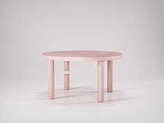 a pink table sitting on top of a white floor