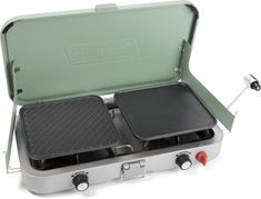 an electric grill with two griddles in the front and one on the side