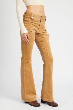 These corduroy pants bring a throwback to the late ’60s and early ’70s when low-rise silhouettes and earthy tones became the uniform for those embracing the bohemian revolution. The button details, perfectly positioned, nod to a utilitarian style that was popular during that time, blending functionality with flair. The subtle flare at the hem mirrors the bell-bottom craze of the ’70s, but with a modernized fit that hugs the hips and thighs before opening out at the calf, giving the leg a sleek, Pants Silhouette, Printed Linen Pants, Fashion Expression, You Look Fab, Tie Dye Pants, Low Rise Pants, Utilitarian Style, Color Pants, Midi Denim