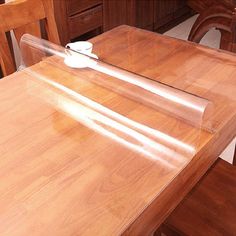 a wooden table with clear plastic covering on it