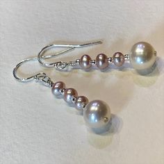 These stylish earrings feature satiny, lustre white Akoya sea pearls, topped with three pink button freshwater pearls. Sterling silver bead, with hypoallergenic 925 sterling French hooks. Grade: AAA+  Pearl size: shy 9 mm Akoya Sea Pearl,  Length: they hang 30 mm from bottom of ear wires                     Arrives gift wrapped in our IndigoLayne signature box. © Sissy Altom All rights reserved. Images may not be reproduced, resold or used without written consent. *Artist Copyright does not tran Elegant Pink Linear Earrings As Gift, Gift Akoya Pearl Dangle Earrings, Pink Dangle Pearl Earrings For Formal Occasions, Elegant Akoya Pearl Dangle Earrings, Elegant Pink Long Drop Earrings, Classic Pink Pearl Earrings For Wedding, Akoya Pearl Dangle Earrings In Pearl White, Elegant Pink Teardrop Pearl Earrings, White Gold Akoya Pearl Dangle Earrings