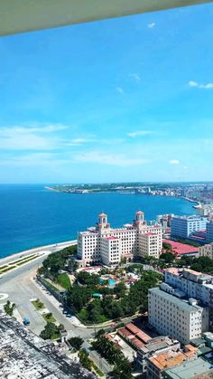 an aerial view of the ocean and buildings