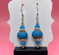 These earrings are made with turquoise lampwork beads, turquoise Chinese crystals, sterling silver bead caps, sterling silver spacer beads and small round sterling silver beads dangling from sterling silver earwires. The earrings measure 2 inches from the top of the earwires. Click here to see other earrings in my shop: https://www.etsy.com/shop/JewelryDesignsByRita?section_id=14765680 I have been designing and making jewelry since 2010. I use only the highest quality materials such as Swarovski Turquoise Czech Glass Dangling Beads Earrings, Turquoise Czech Glass Round Bead Earrings, Turquoise Czech Glass Beaded Earrings, Turquoise Czech Glass Dangling Earrings, Turquoise Czech Glass Earrings With Dangling Beads, Artisan Turquoise Czech Glass Earrings, Turquoise Round Beaded Earrings, Artisan Czech Glass Turquoise Earrings, Adjustable Turquoise Earrings With Spacer Beads