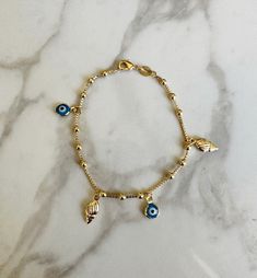 "Perfect worn on its own or layered with our other bracelets. 18k gold filled.  7\" length *18k gold filled is a more affordable alternative to solid gold jewelry. Gold filled is a layer of gold bonded onto a base metal with heat and pressure that contains 100+ times more gold than gold plated jewelry.  *It is very durable and tarnish resistant.  *With proper care, gold filled jewelry can last several years. Avoid contact with harsh chemicals, perfumes, water, etc.  *Gold filled jewelry can be worn by people with sensitive skin because it is hypoallergenic, lead free and nickel free." Nickel Free 14k Gold-filled Bracelet, Nickel-free 14k Gold-filled Gold Bracelet, 14k Gold Filled Evil Eye Jewelry, Handmade Gold Bracelet In 14k Gold Filled, Gold-plated Evil Eye Bracelet For Gift, Handmade 14k Gold Filled Yellow Gold Bracelets, Handmade 14k Yellow Gold-filled Bracelets, Handmade 14k Yellow Gold Filled Bracelets, Handmade Dainty Gold Plated Charm Bracelet