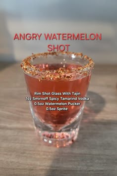 an angry watermelon shot in a glass on a wooden table with text overlay