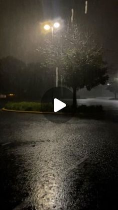 an image of a street at night with the light on and rain coming in from behind