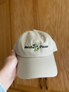 "Do you love a nice \"favorite food\" hat as an accessory and a nice addition to your closet and outfits? this embroidered \"Matcha Please\" retro iced matcha latte baseball cap is the perfect unique piece to add to your collection! The perfect hat for matcha lovers and coffee lovers who love a good iced drink. This embroidered matcha latte dad hat is an original hand drawn design and is part of our \"hats\" collection. * 100% chino cotton twill * Green Camo color is 35% chino cotton twill, 65% polyester * Unstructured, 6-panel, low-profile * 6 embroidered eyelets * 3 ⅛\" (7.6 cm) crown * Adjustable strap with antique buckle * Blank product sourced from Vietnam or Bangladesh This product is made especially for you as soon as you place an order, which is why it takes us a bit longer to deli Casual Mini Snapback Hat With Letter Print, Casual Baseball Cap Gift, Casual Hats With Letter Print For Gifts, Casual Letter Print Hats As Gift, Casual Mini Baseball Cap With Letter Print, Casual Mini Hats For Gifts, Casual Embroidered Hats For Gifts, Casual Embroidered Hat For Gift, Casual Mini Hat With Short Brim As Gift