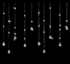 some white diamonds hanging from the side of a black wall