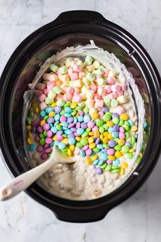 a crock pot filled with cereal and marshmallows