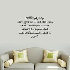 a living room with a couch and wall decal that says always pray to have eyes that see the best in people