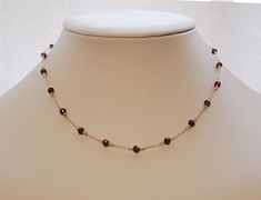 "This minimalist natural garnet necklace is perfect for both everyday and evening looks. The deep red garnets are strung on an option of either a sterling silver or 14K yellow gold filled chain to a length of your choosing and finished with a elegant filigree hook clasp. Necklace pictured measures 16 inches. D E T A I L S - Made with 4 mm faceted red garnets - Option of sterling silver or 14K gold filled chain - Finished with filigree hook clasp - Made to order L E N G T H - Necklaces pictured m Garnet Jewelry Dainty, Red Garnet Jewelry, Double Strand Pearl Necklace, Star Garnet, Real Pearl Necklace, Black Pearl Necklace, Dress Idea, Clasp Necklace, Garnet Necklace