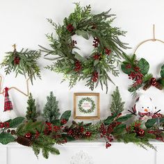 christmas wreaths are hung on the mantle