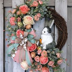 a wreath with flowers and a bunny on it