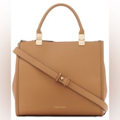 New With Tag. The Sophia Tote From Calvin Klein Has Plenty Of Room And Charm With Multiple Compartments And Faux-Leather Exterior. Large Sized Bag; 14"W X 12-3/4"H X 6-1/2"D (Width Is Measured Across The Bottom Of Handbag); 2.9 Lbs. Approx. Weight 5-1/2"L Top Handles Magnetic Snap Closure Logo Hardware Interior Zip Middle Compartment, Double Interior Slip Pocket, Interior Zip Pocket Tablet Compatible (Std. Size 8"-10") Polyurethane; Lining: Polyester Spot Clean Brown Square Satchel With Branded Hardware, Square Bags With Branded Hardware, Everyday Square Shoulder Bag With Branded Hardware, Office Satchel With Branded Hardware And Double Handle, Modern Shopping Bag With Branded Hardware, Beige Top Handle Satchel With Branded Hardware, Chic Square Bags With Branded Hardware, Calvin Klein Luxury Shoulder Bag For Daily Use, Luxury Calvin Klein Shoulder Bag For Daily Use