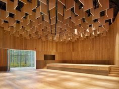 an empty room with wooden walls and ceiling