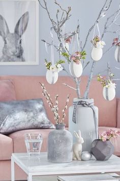 a living room with pink couches and decorations on the table in front of it