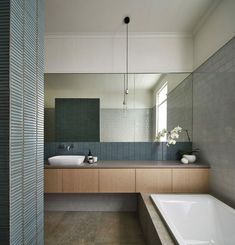 a large bathroom with two sinks and a bathtub in the middle of the room