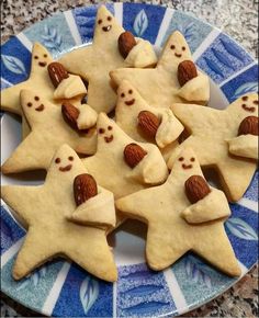 some cookies are on a blue and white plate with nuts in the shape of stars